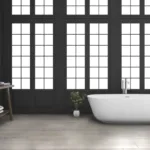 Modern bathroom with freestanding tub and large windows