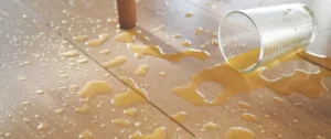 Spilled drink on wooden floor.