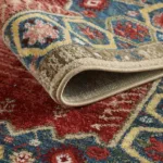 Folded colorful ornate rug on a floor