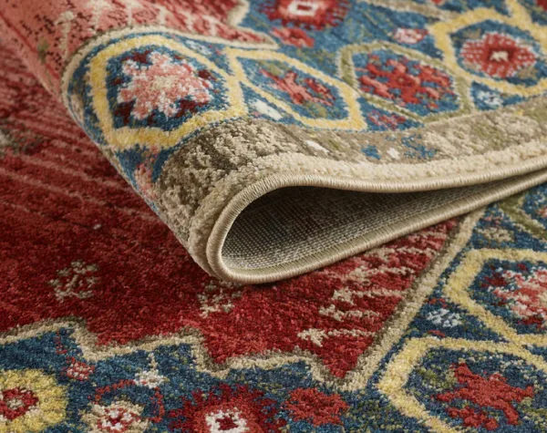 Folded colorful ornate rug on a floor