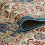 Folded patterned area rug close-up view.