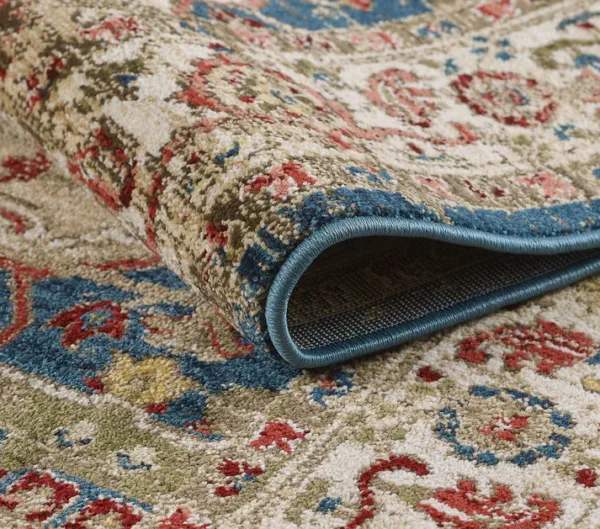 Folded patterned area rug close-up view.