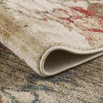 Close-up of a rolled beige and red rug