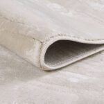 Close-up of rolled beige rug texture