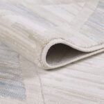 Close-up of folded beige patterned rug