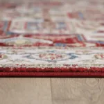 Close-up of red patterned rug on wooden floor