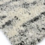 Close-up of textured wool carpet, black and white