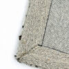 Close-up of fabric corner with hem stitching.