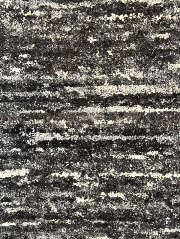 Close-up of textured gray and white carpet design.