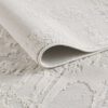 Textured beige rug with intricate patterns