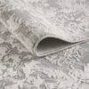 Folded gray floral-patterned carpet texture.