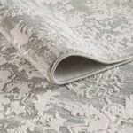 Folded gray floral-patterned carpet texture.