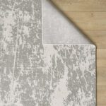 Gray abstract rug on wooden floor