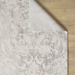 Gray damask area rug on wooden floor