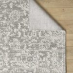 Gray patterned rug on wooden floor