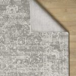 Gray patterned rug on wooden floor