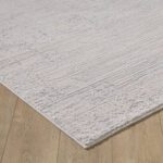 Gray textured rug on wooden floor