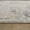 Gray textured rug on wooden floor.