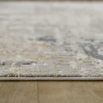 Gray textured rug on wooden floor.