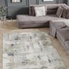 Modern living room with abstract rug and sectional sofa.