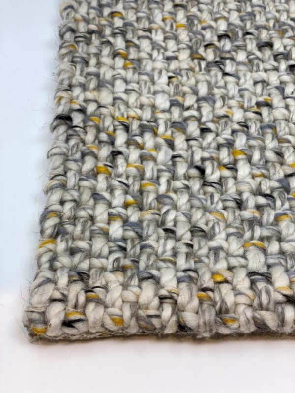 Close-up of textured woven carpet sample.