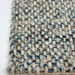 Close-up of woven carpet with blue accents.