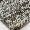 Close-up of textured wool rug corner.