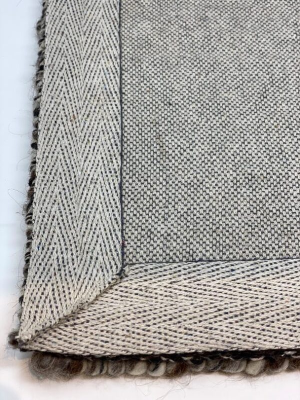 Close-up of patterned woven rug edge