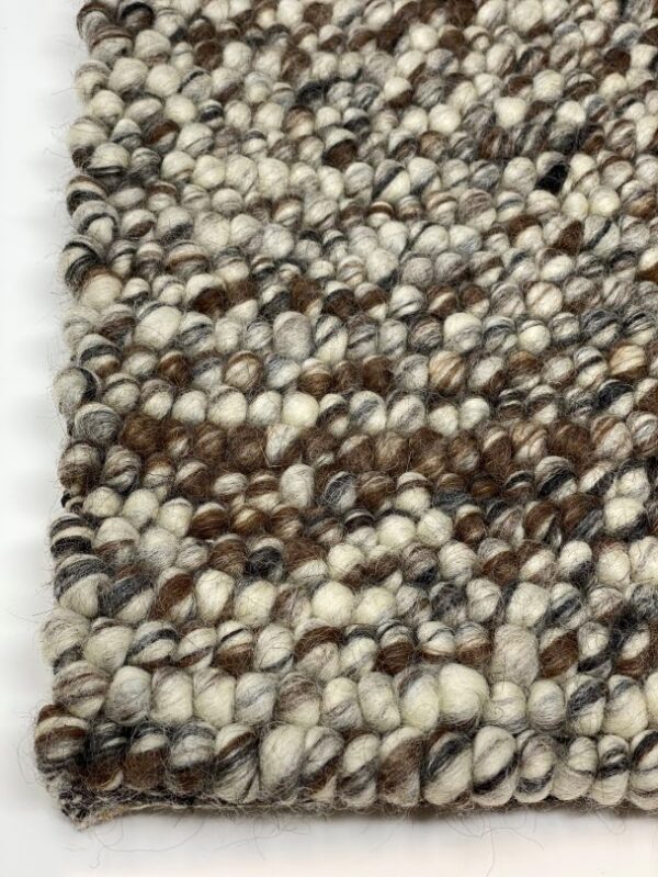 Close-up of textured woven wool rug.