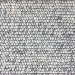 Close-up of textured gray wool carpet.