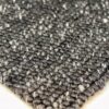 Close-up of woven gray textured rug corner.