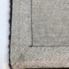 Close-up of textured gray woven fabric with edges