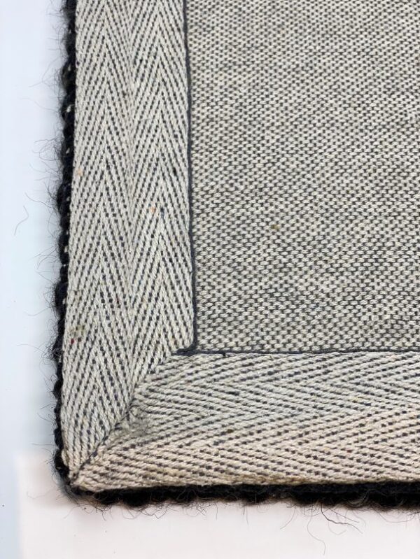 Close-up of textured gray woven fabric with edges