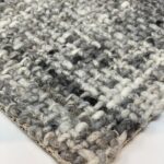 Close-up of woven gray and white rug texture