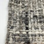 Close-up of gray woven textile texture.