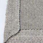 Close-up of textured woven rug corner