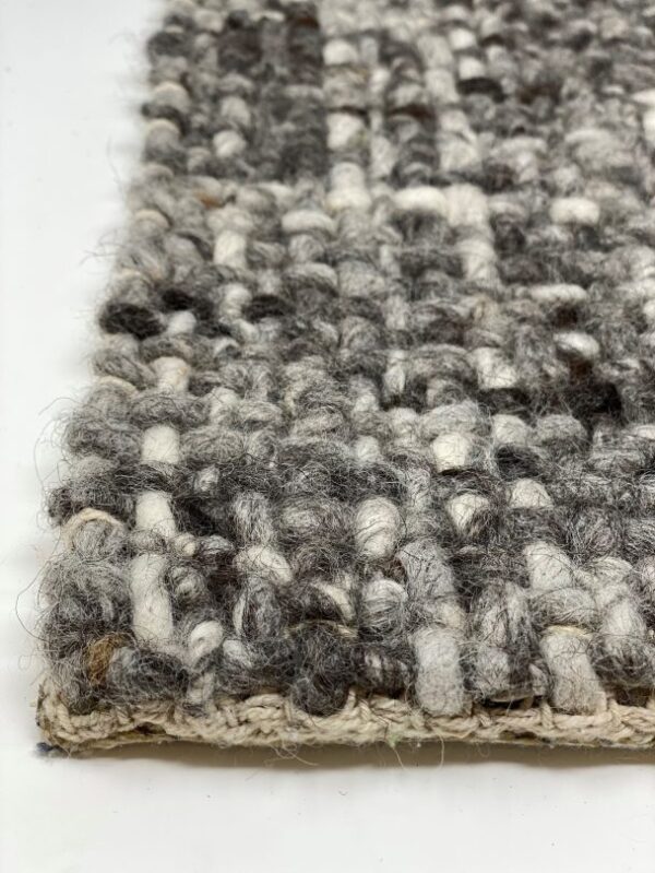 Close-up of textured woven wool rug