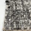 Close-up of textured, woven gray rug