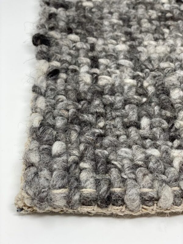 Close-up of textured, woven gray rug