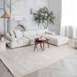 Elegant living room with white sofa and decor.