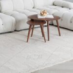 Two wooden tables on a light rug