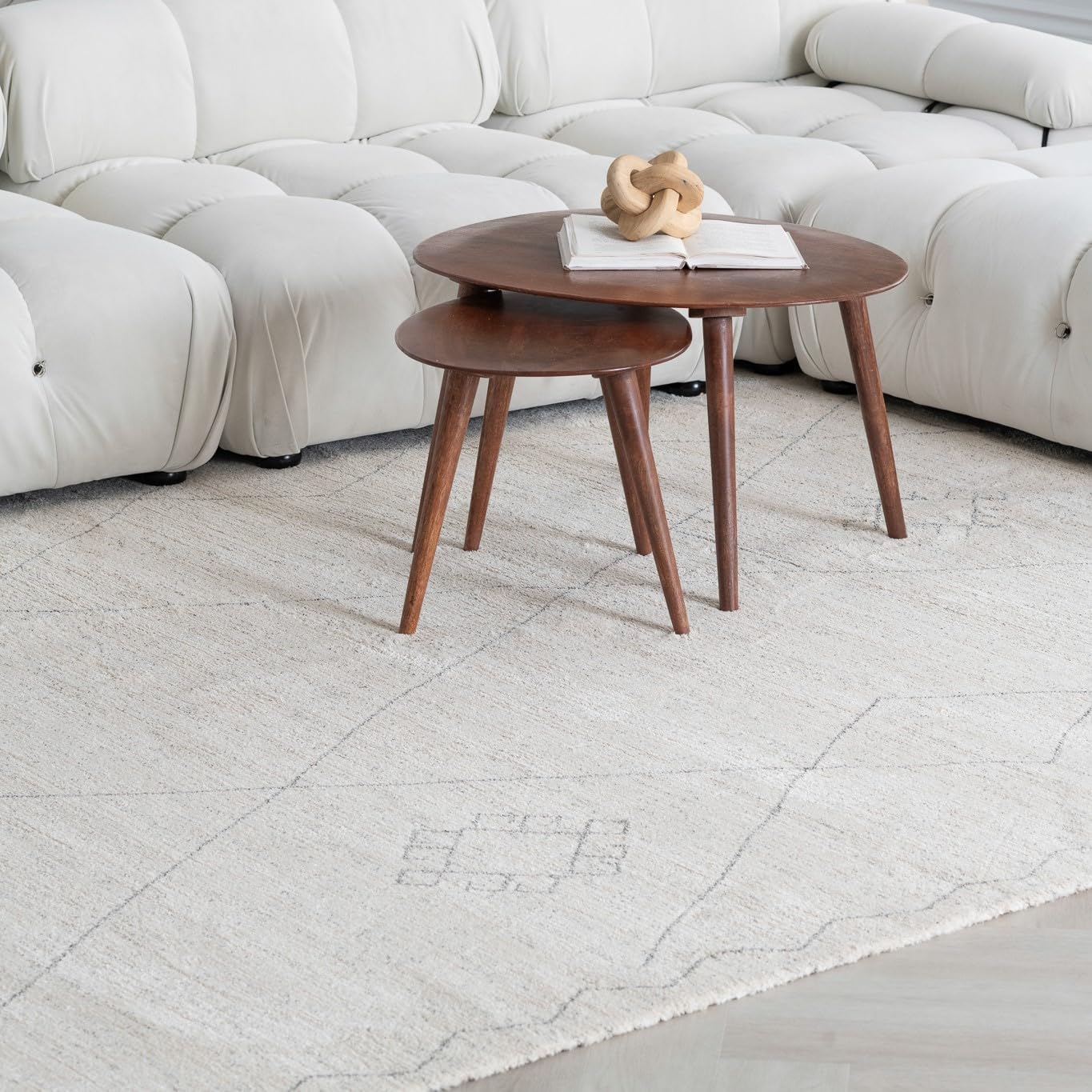 Two wooden tables on a light rug