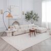Elegant living room with white sofa and decor.