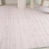 Light beige textured area rug in room corner.