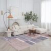 Modern living room with white sofa and rug.