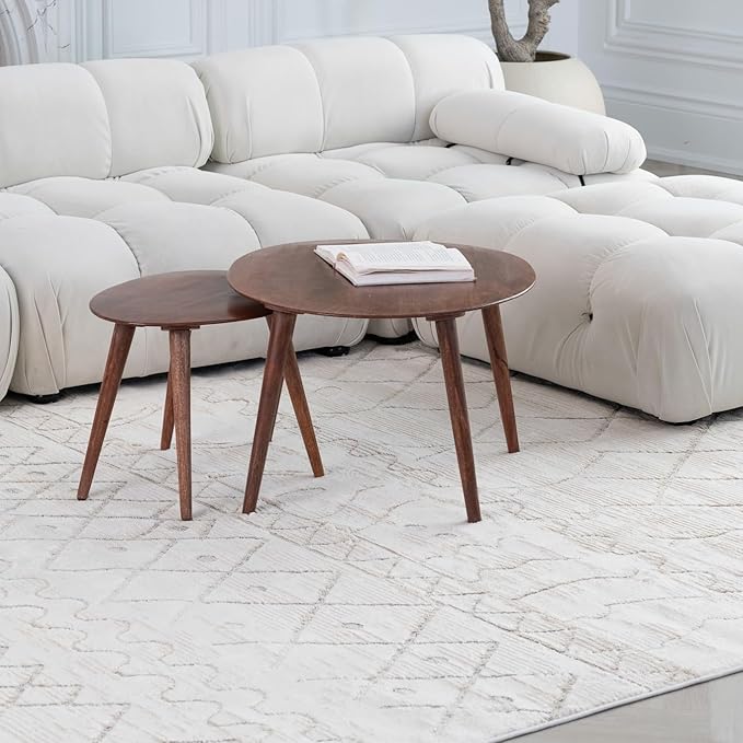 Modern living room with white sofa and tables.