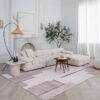 Elegant living room with white sofa and rug.
