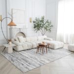 Modern living room with white furniture and plants.