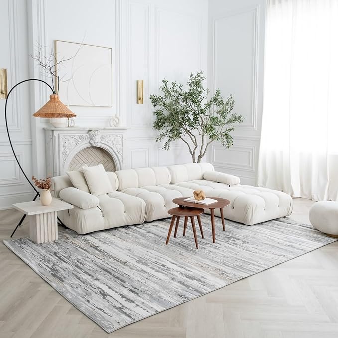 Modern living room with white furniture and plants.