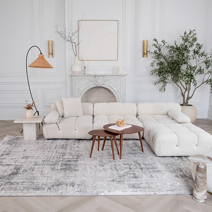 Elegant living room with white sofa and fireplace.